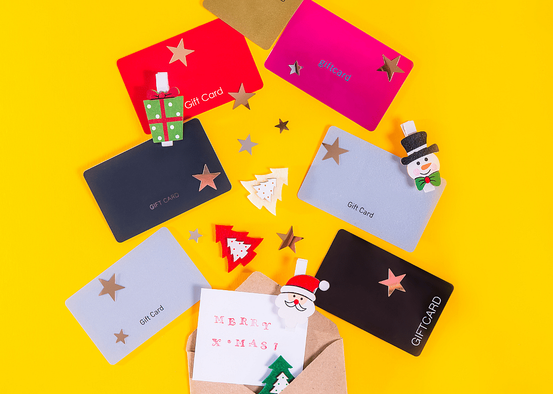 An image of various gift cards on a yellow background.