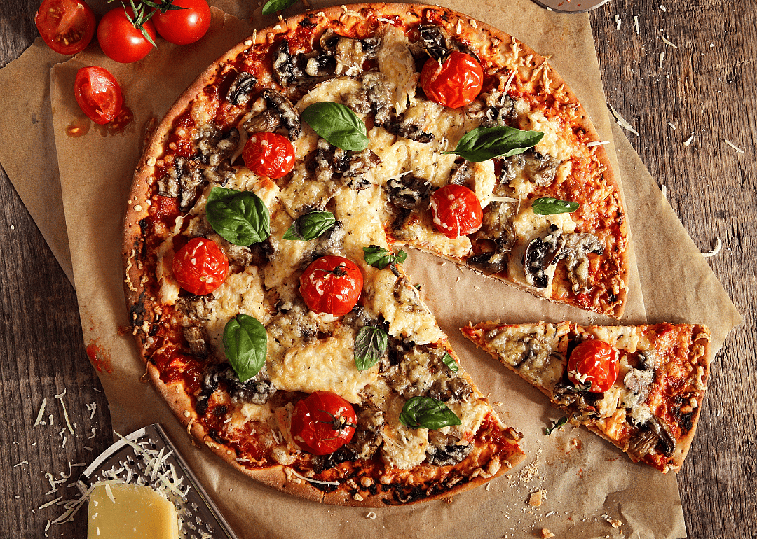 Pizza with whole tomatoes.