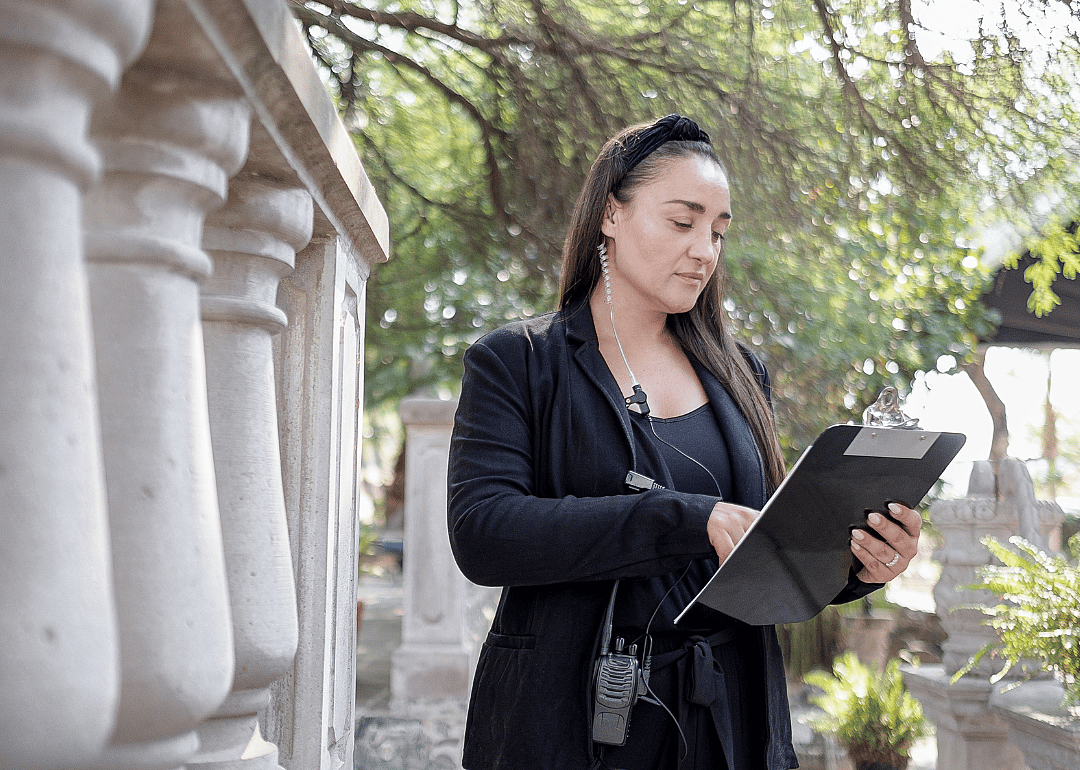 A woman with a clipboard at an event site.