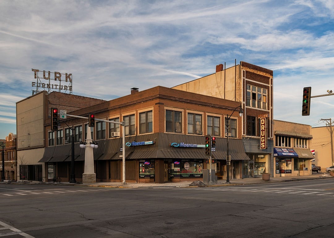 A street in Downtown Kankakee with a furniture store, a drugstore, and an insurance office.