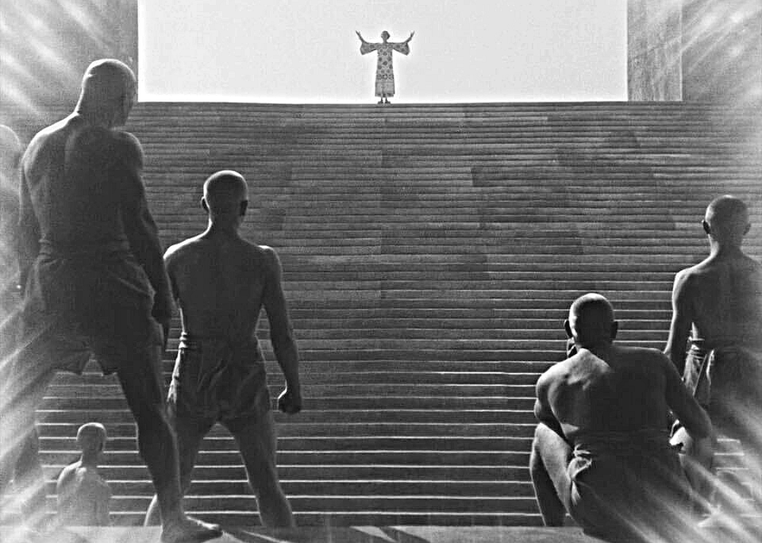 Men look on at their master in dystopian world