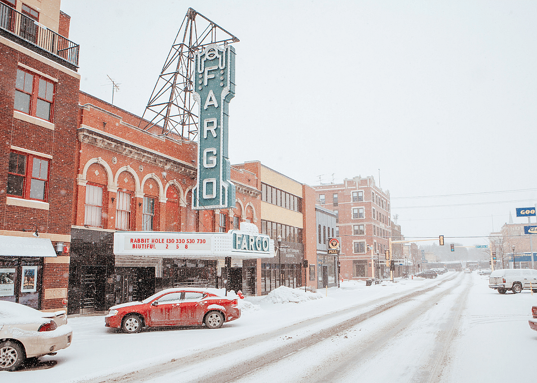 Brick buildings along the snowy street.