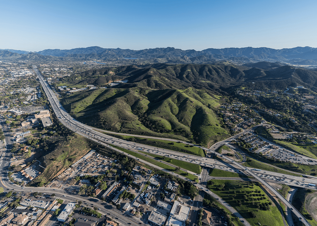 An aerial view of Thousand Oaks and a highway in the foothills.