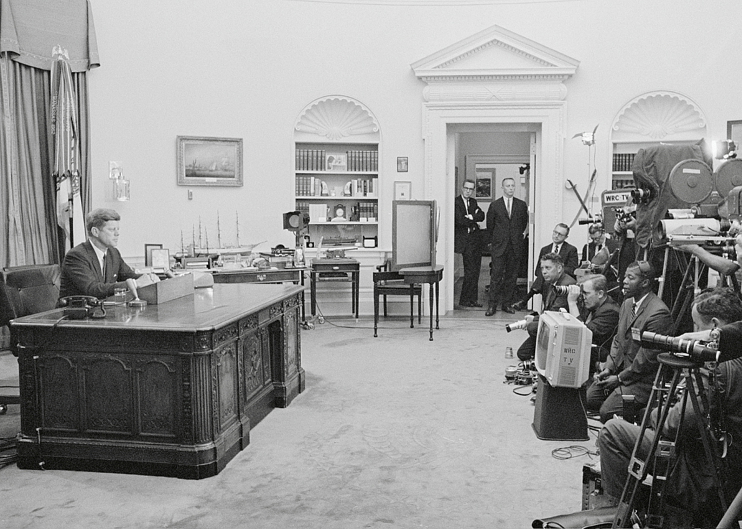 President John F. Kennedy in the Oval Office, being recorded by the media as he addresses the nation on the issue of civil rights. 