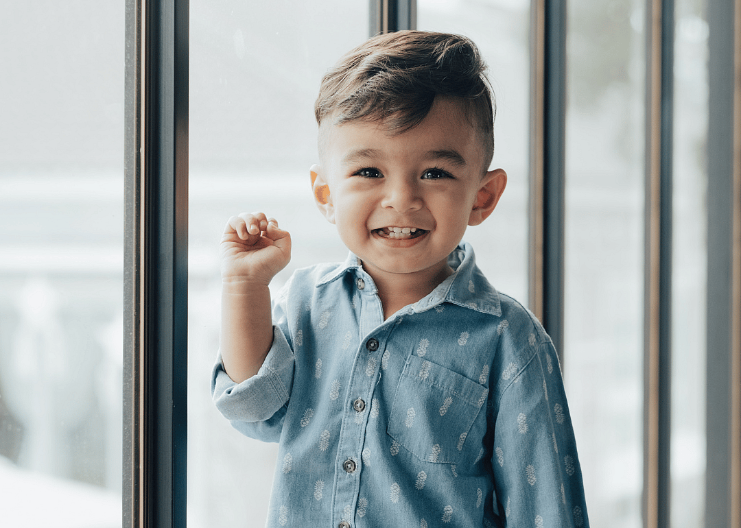 A smiling boy standing. 