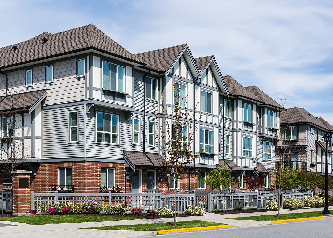 A modern apartment complex painted grey and white.