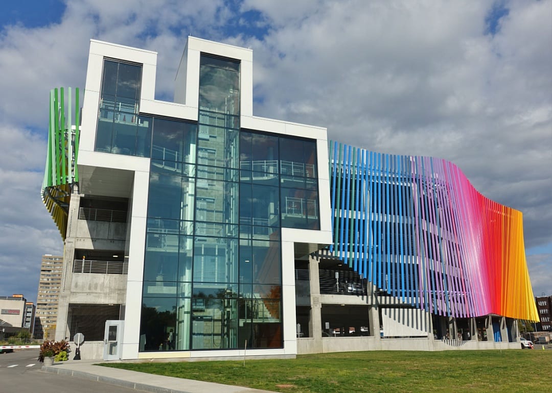 The exterior of the Strong National Museum of Play, which has a bright rainbow colored structure wrapping around it.
