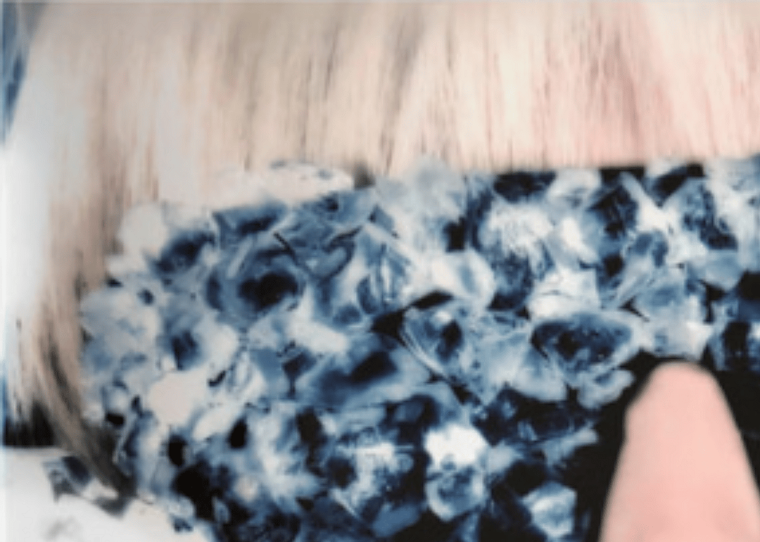 Blonde bangs and dark glasses coated in diamonds.