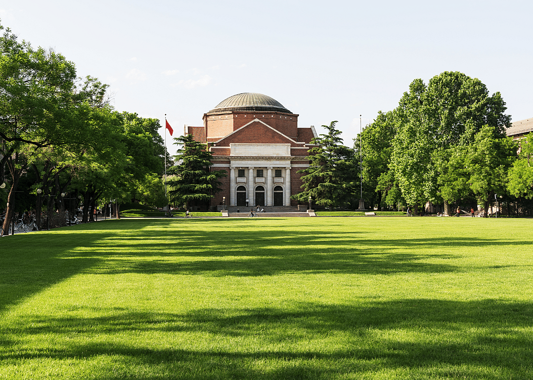 An old brick building with a green lawn at Tsinghua University.