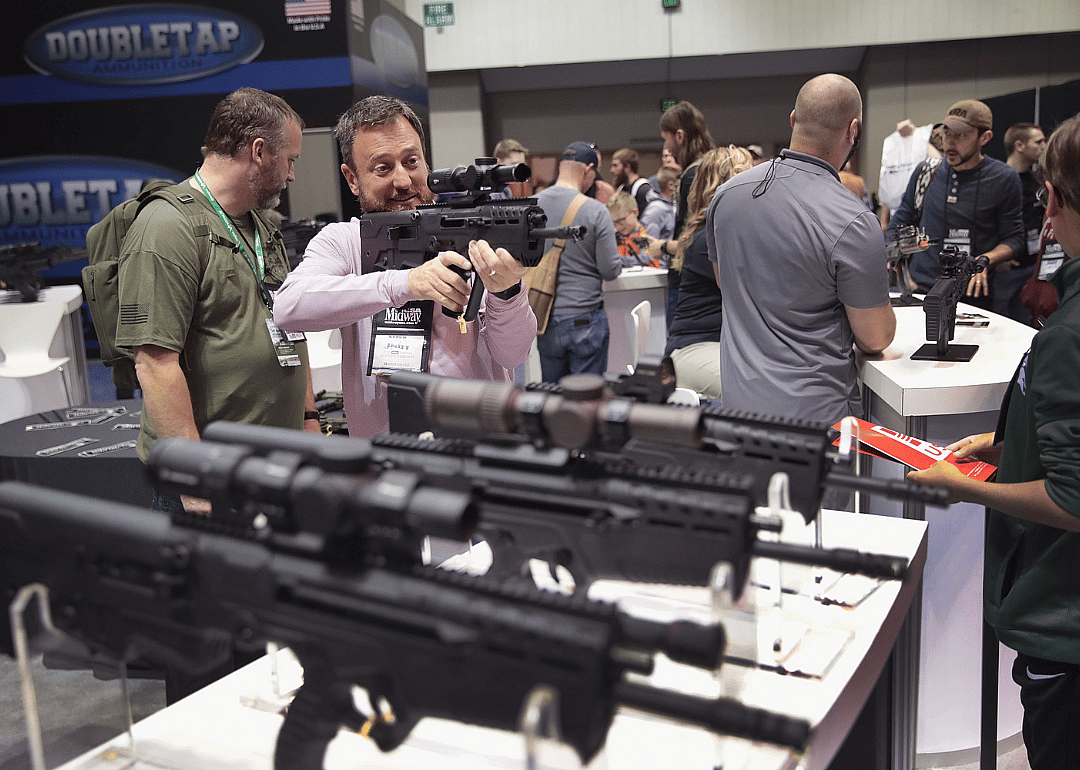 Guests shopping for firearms and accessories at a NRA Annual Meetings & Exhibits in Indianapolis.