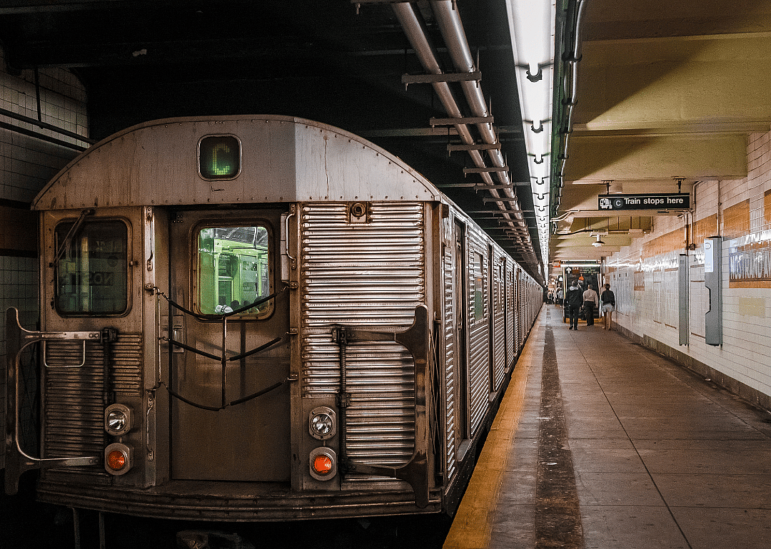A gray train stopped in a subway station.