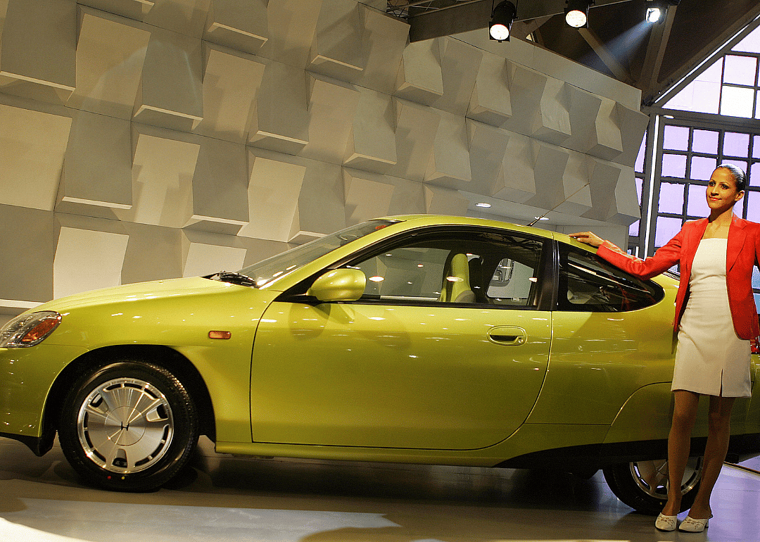A model posing with a Honda Insight.