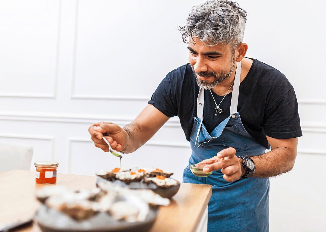 A chef prepares a dish to serve.