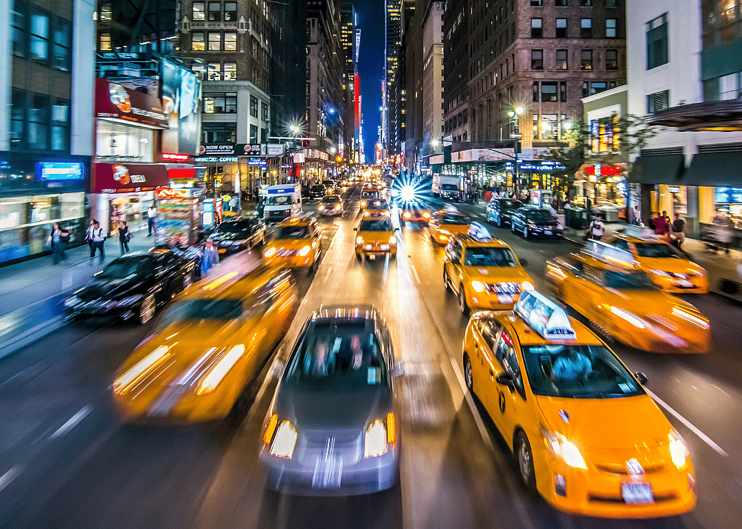 A street-level view of New York City at night.
