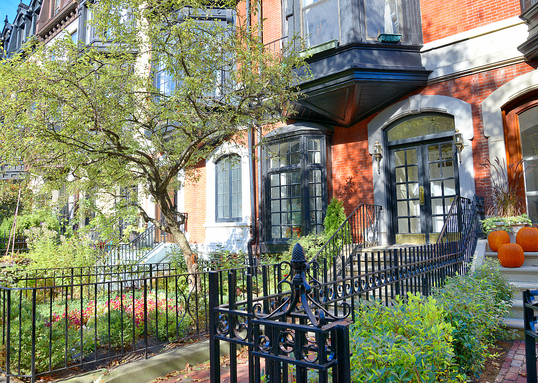 Boston townhomes with pumpkins outside them for Halloween.