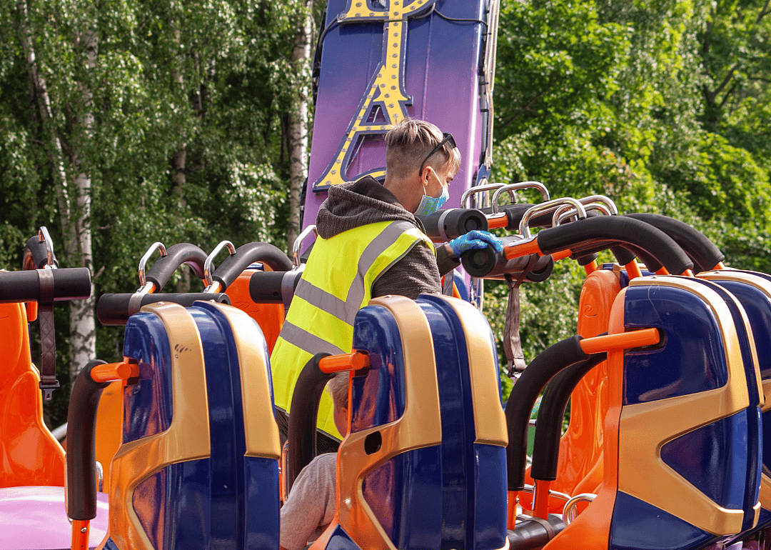 A worker cleaning an amusement park ride.