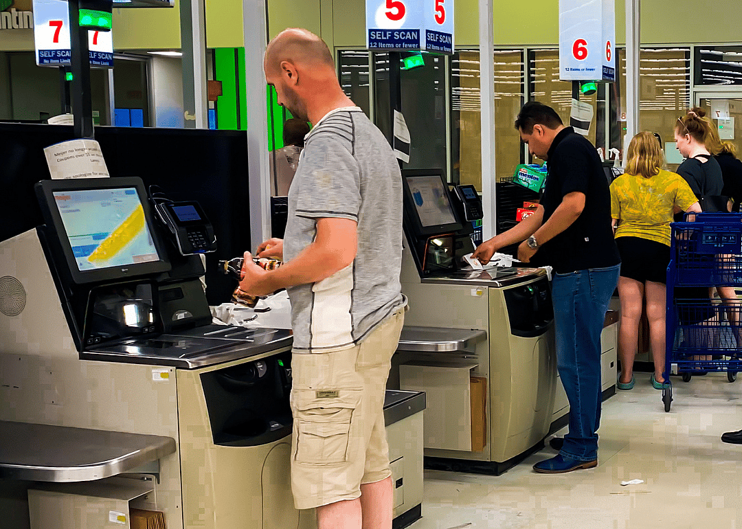 Customers paying with credit cards at a self-checkout station at a grocery store in Detroit, Michigan.