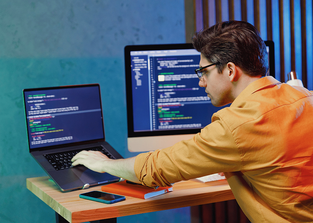 A data scientist working on a laptop.