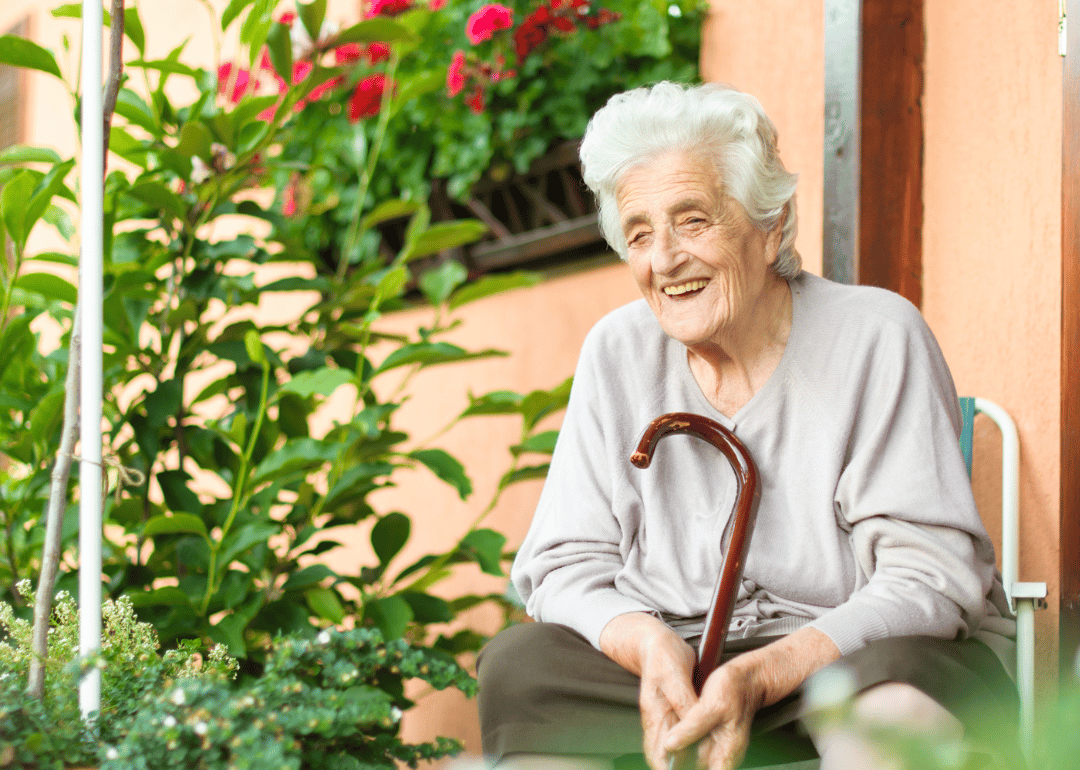 A happy senior woman sitting outside