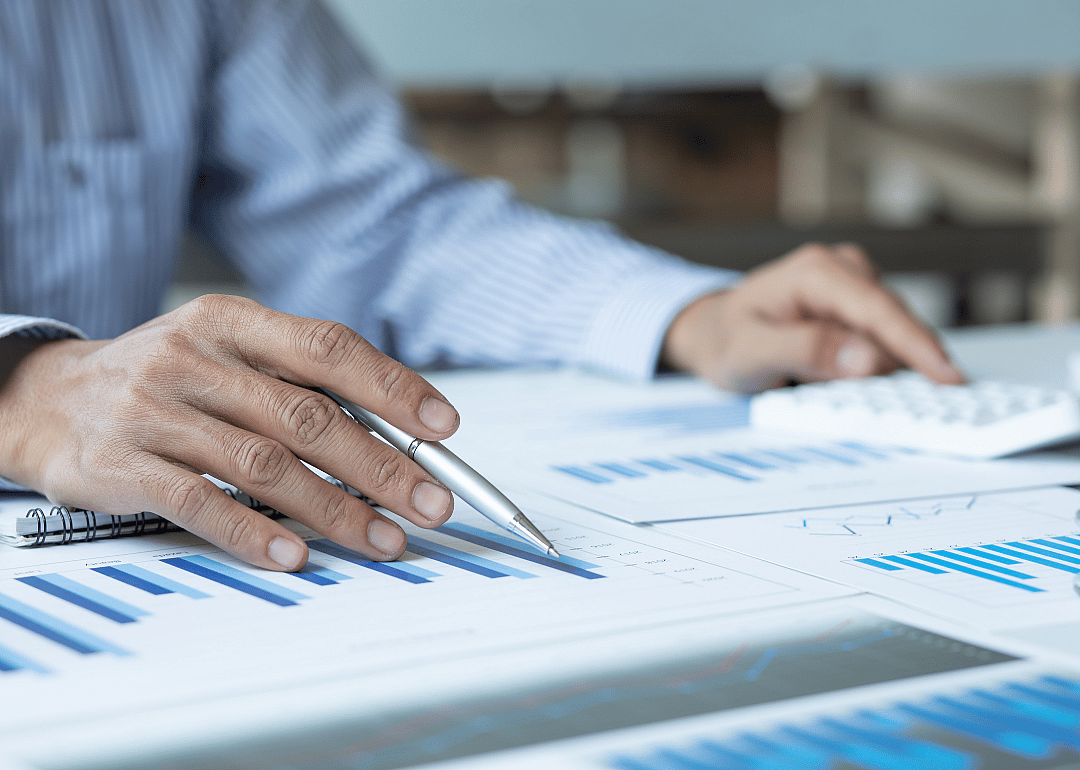 A financial manager looking a printed graphs