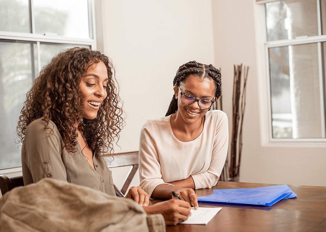 A tutor working with a student at their home