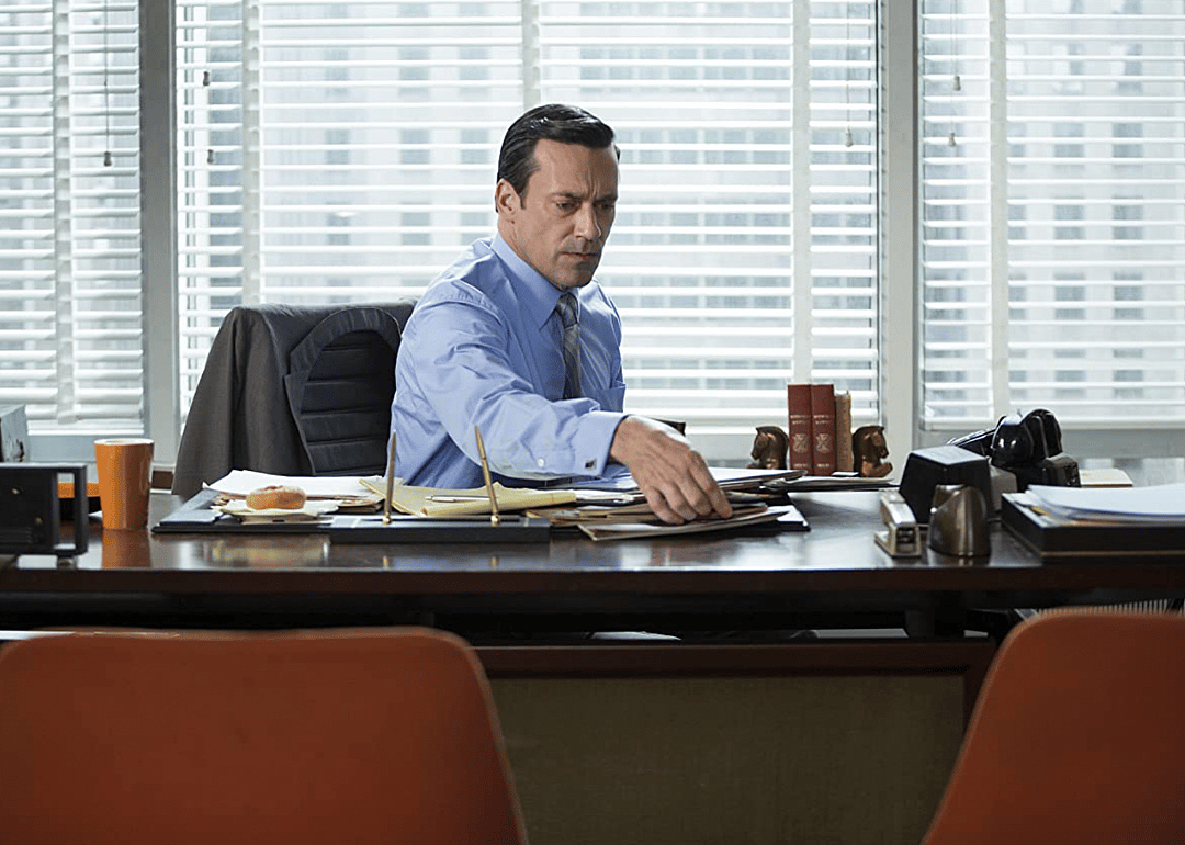 Jon Hamm sits behind his desk in a scene in a 2007 episode of the TV show, Mad Men.