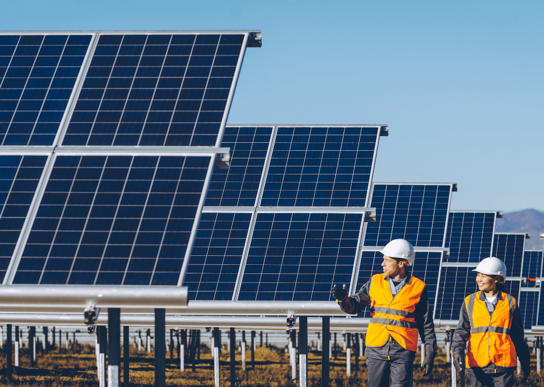 Two young people work at a solar power station