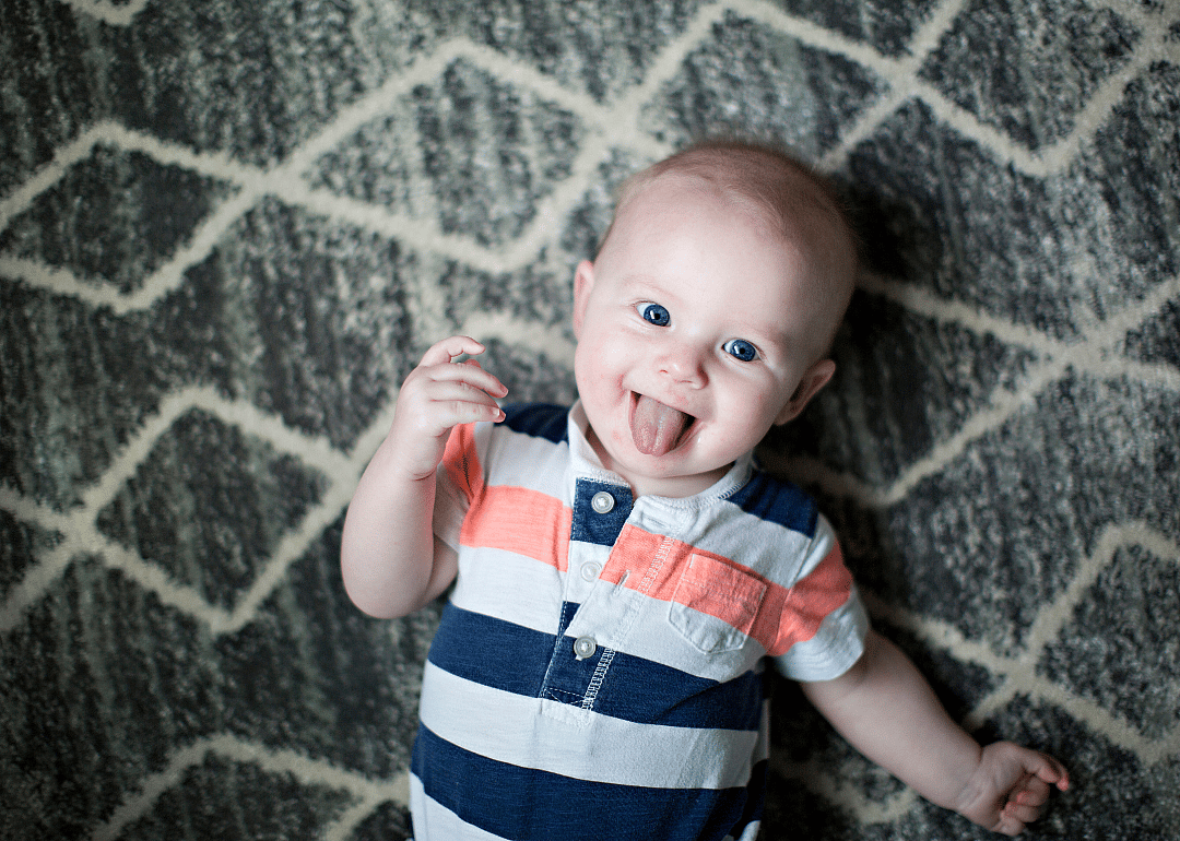 A baby sticking their tongue out.