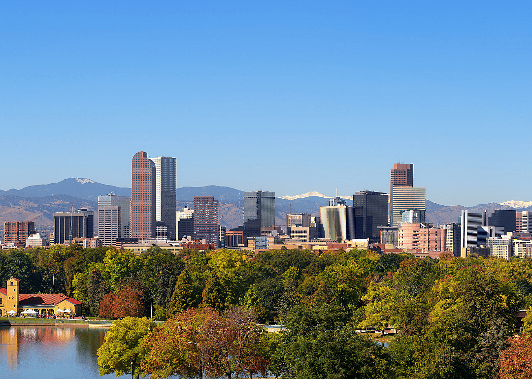 The skyline of downtown Denver with the Rocky Mountains in the background.