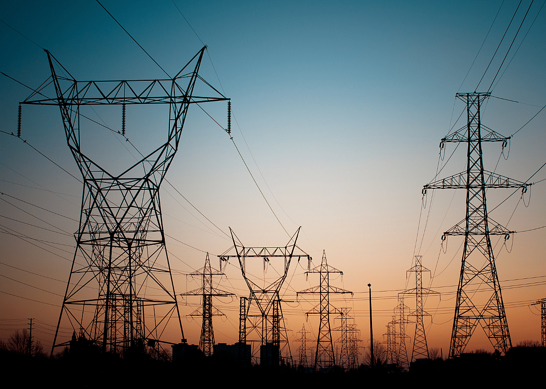 A long line of electrical transmission towers carrying high voltage lines.