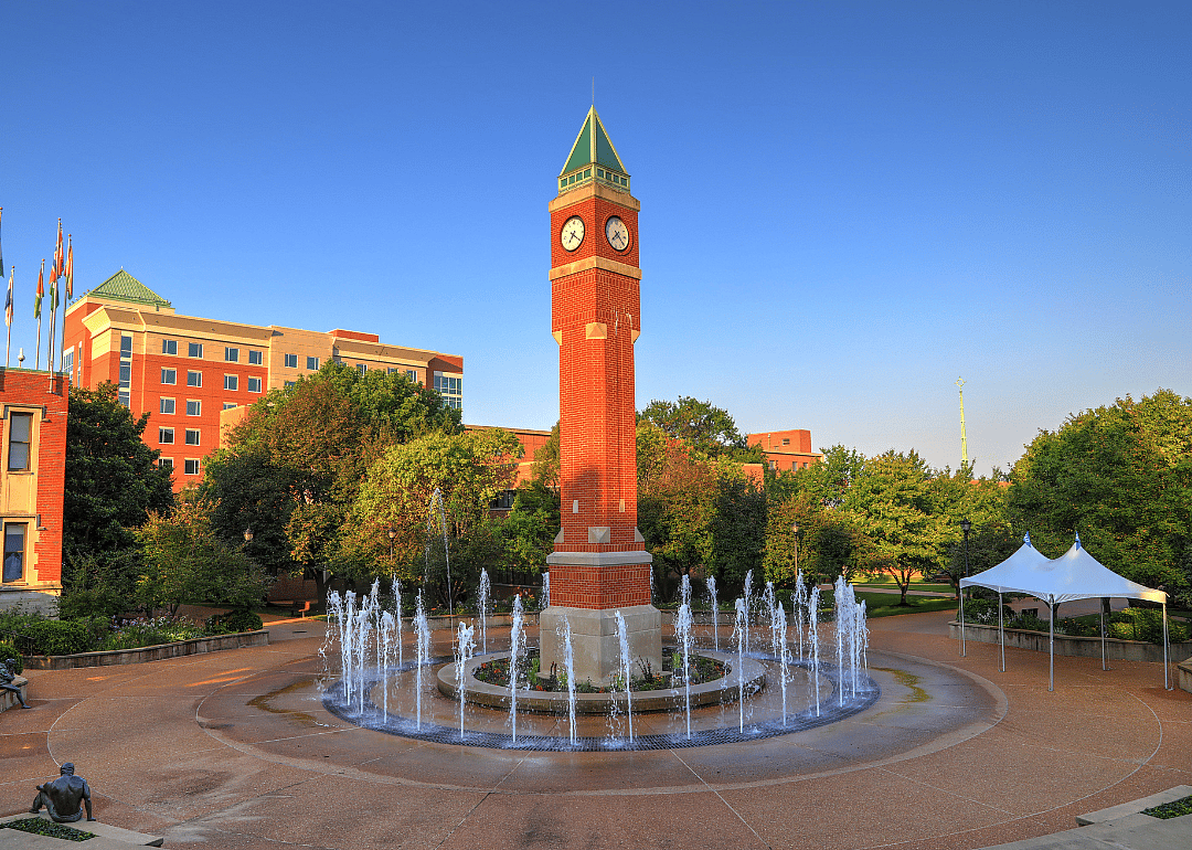 A clock tower and fountain at Saint Louis University.