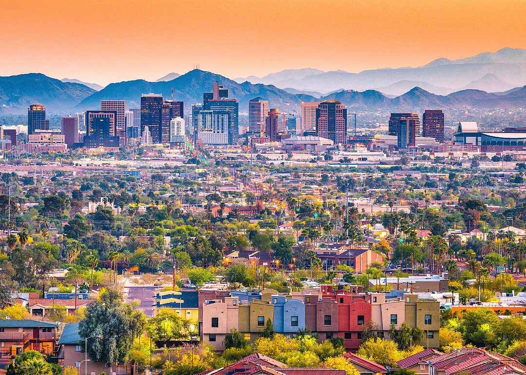 Phoenix's skyline with mountains in the background as seen from afar.