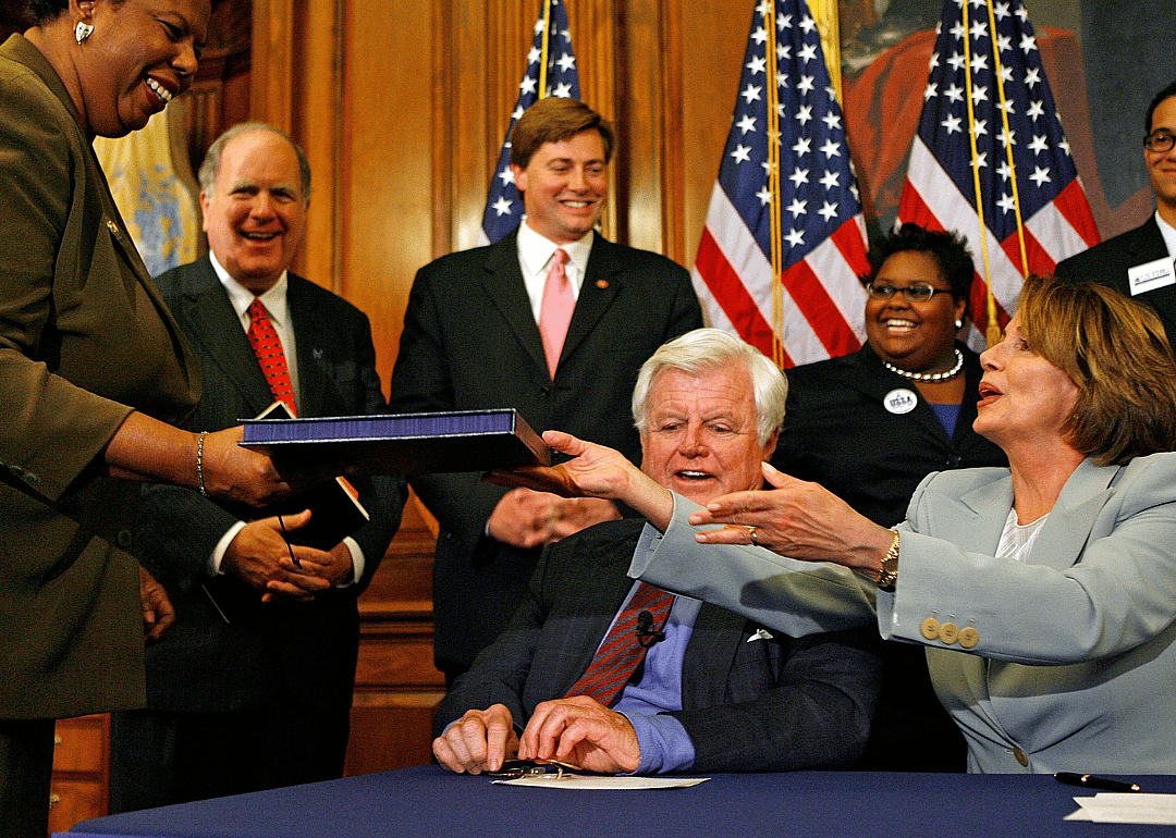 Speaker of the House Nancy Pelosi handing the College Cost Reduction Act of 2007 to Clerk of the House Lorraine C. Miller. The bill increases access to Pell Grants.