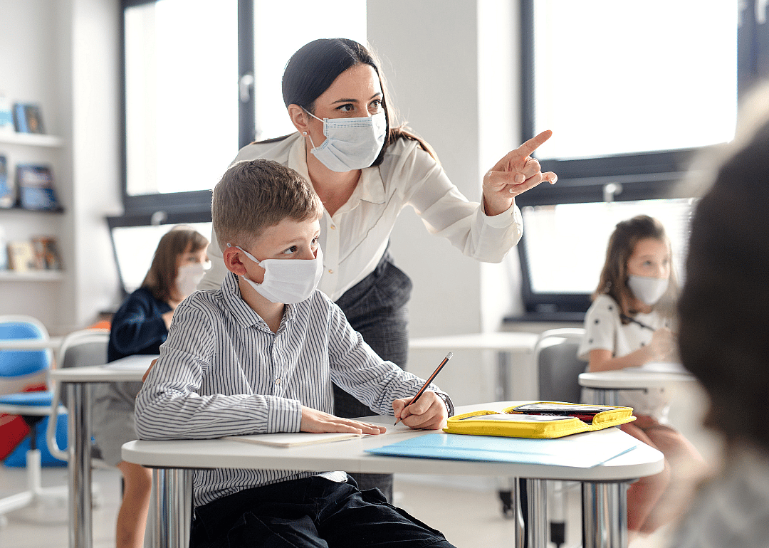 A teacher helping a student in her classroom