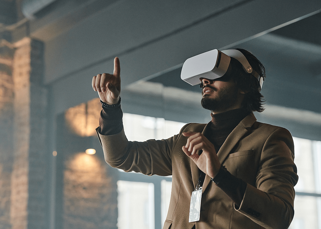 A person wearing VR goggles in an office.