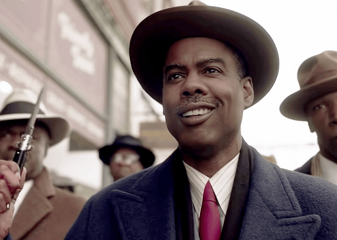 Loy Cannon (Chris Rock) wielding a pocket knife and smiling