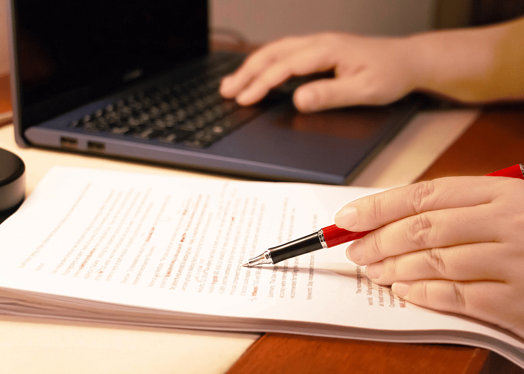 A proofreader works on documents.