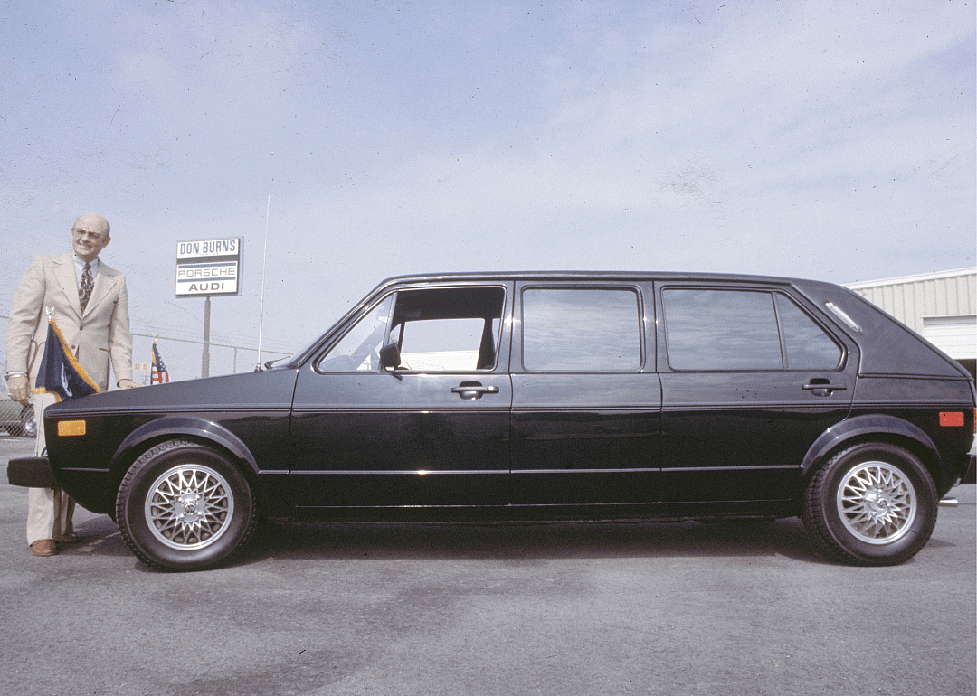 A man standing next to a 77 VW Rabbit.