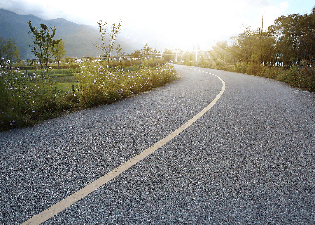 A winding country road at sunset.