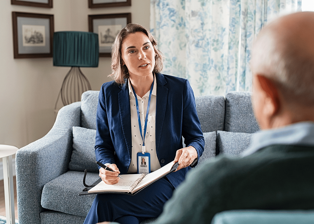 A social worker talking to a person during a home visit.