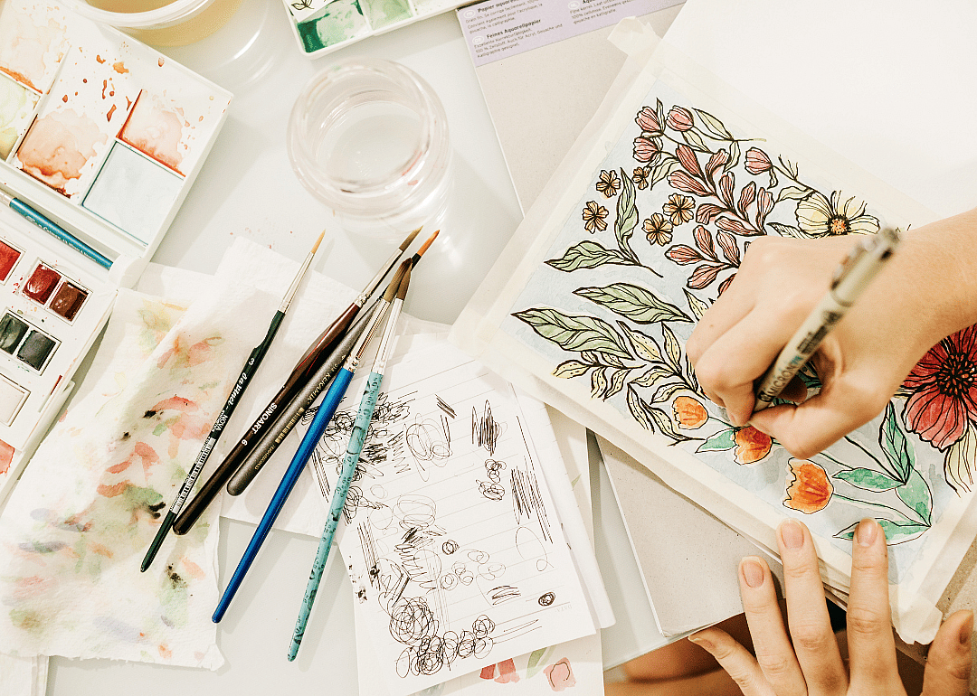 Artist sketches plants in a notebook
