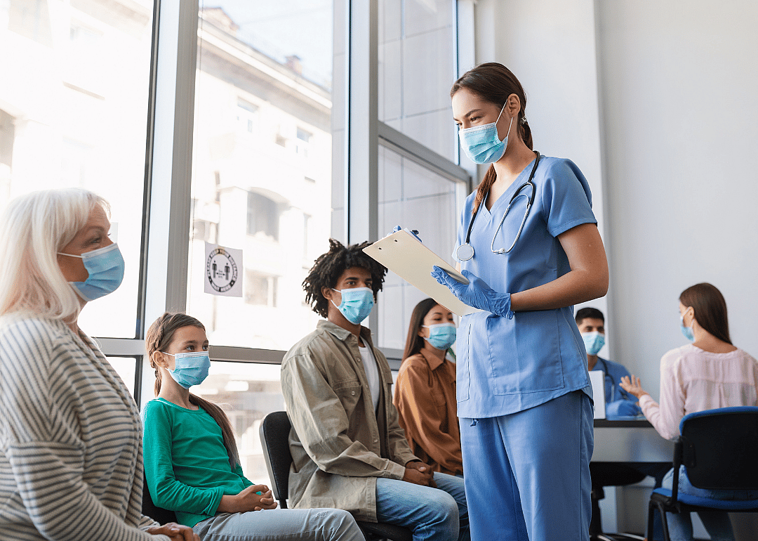 A registered nurse helping patients at a vaccination clinic during the pandemic.