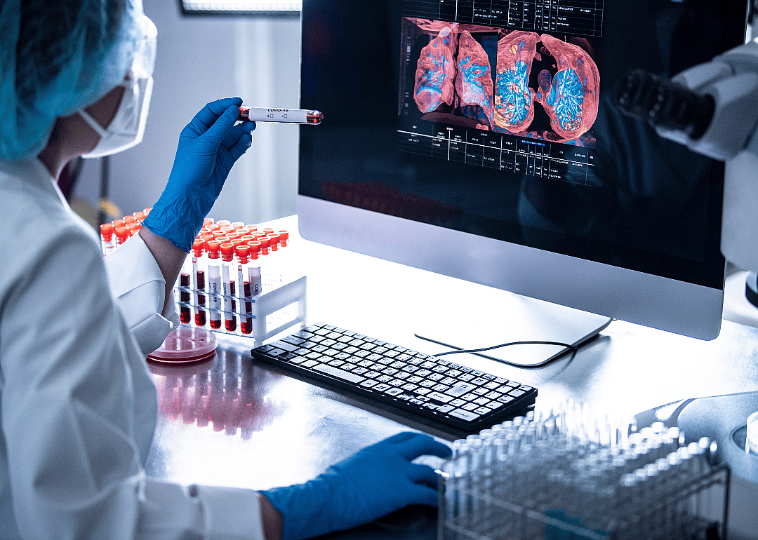 An epidemiologist using medical sample tubes.