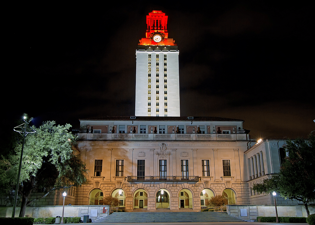 The University of Texas - Austin's tower glowing at night in white/orange to celebrate an athletic victory.