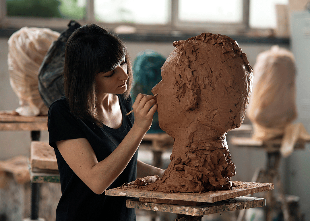A student sculpting a bust.