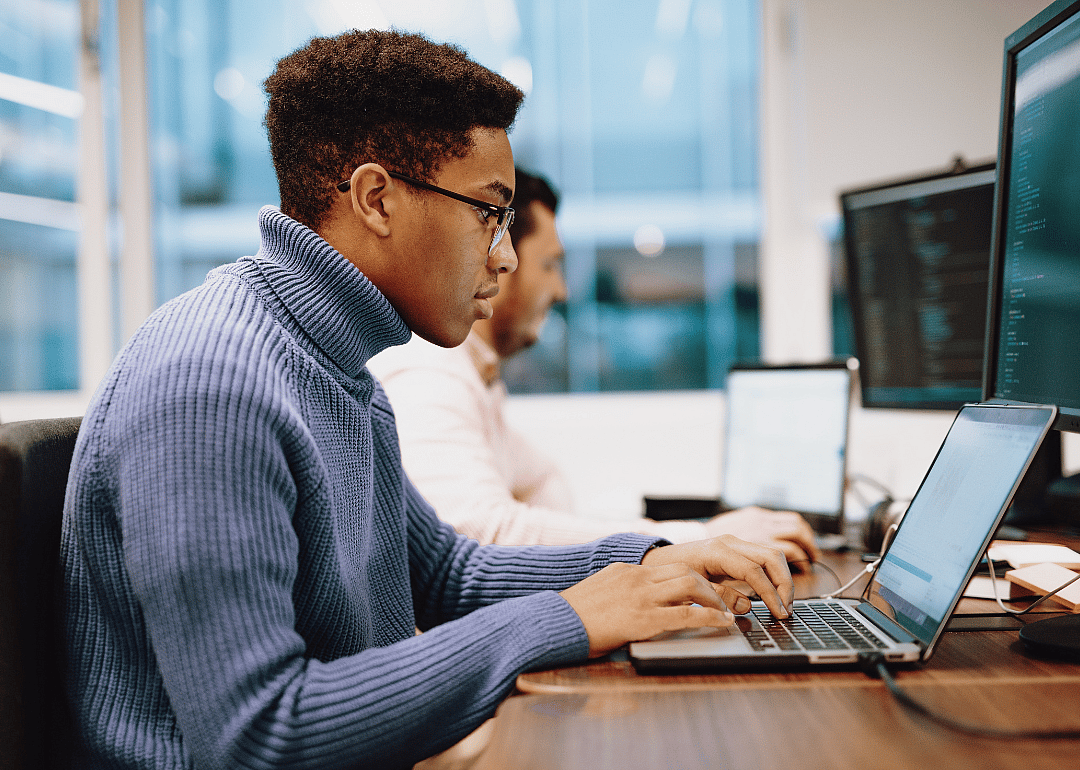 A software developer working at a desktop computer.