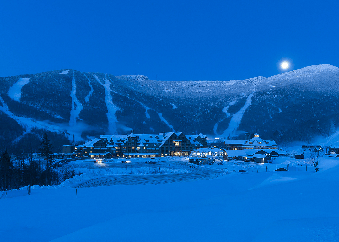 The moon setting over a snow-covered Mt. Mansfield in Stowe.