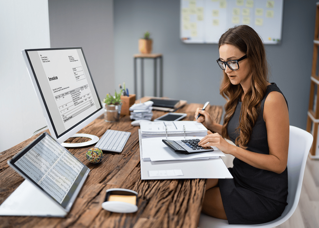 An accountant processing an invoice at their desk.