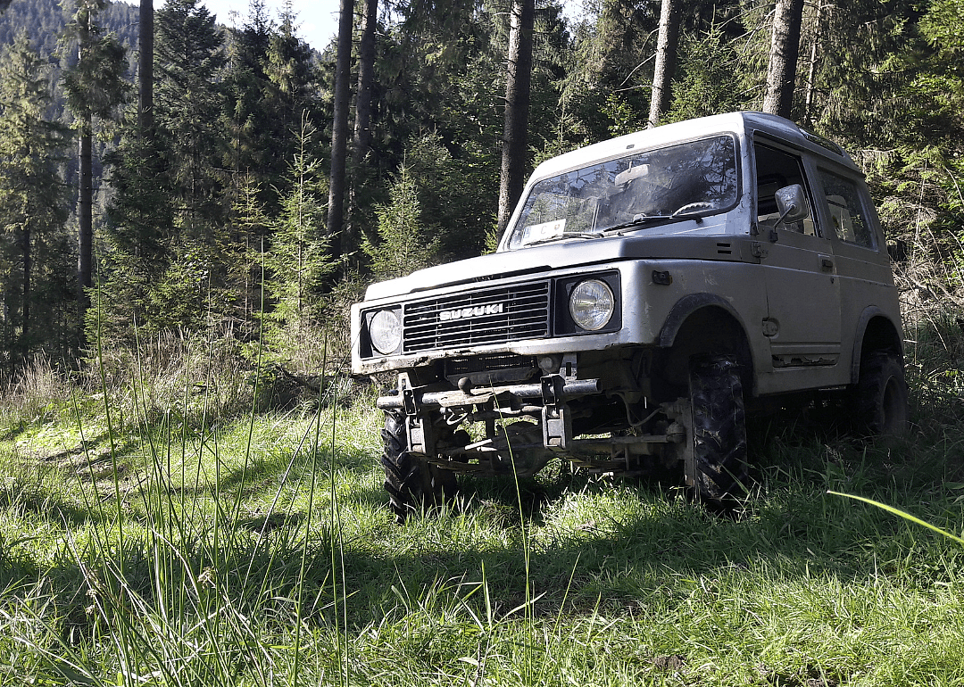 A Suzuki Samurai parked in a mountain area.