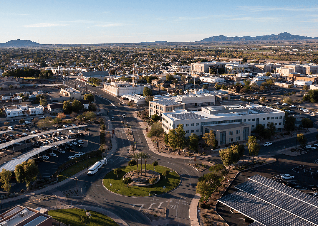 Aerial view of a city surrounded by mountains.
